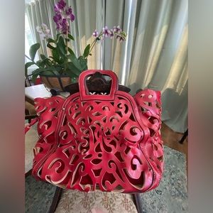 Red leather purse with cut outs